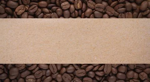 Roasted coffee beans background with blank brown paper label Stock Photos