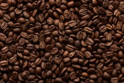 Roasted coffee beans background. Close up top view. Stock Photos