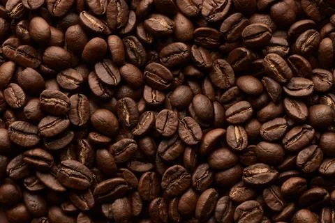 Roasted coffee beans background. Close up top view. Stock Photos