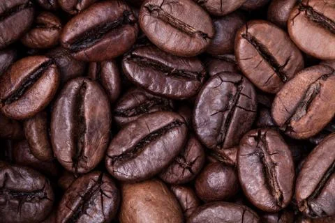 Roasted coffee beans background concept. Stock Photos