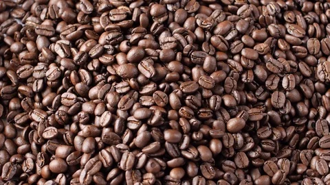 Roasted Coffee Beans Being scooped up and poured out Video stock 99125136