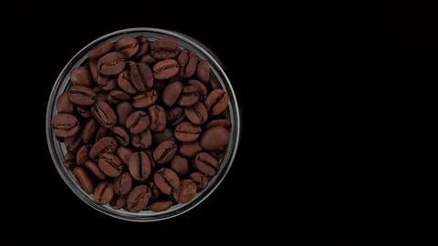 Roasted coffee beans on black background, top view rotation. 4K UHD video Stock Footage 158100083