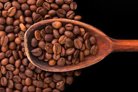 Roasted coffee beans on a black background Stock Photos