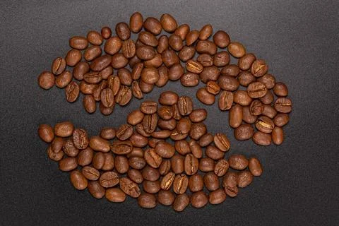 Roasted coffee beans on a black background Stock Photos