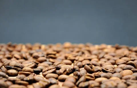 Roasted coffee beans on a black background. Place for text Stock Photos