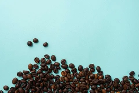 Roasted coffee beans on a blue background Stock Photos