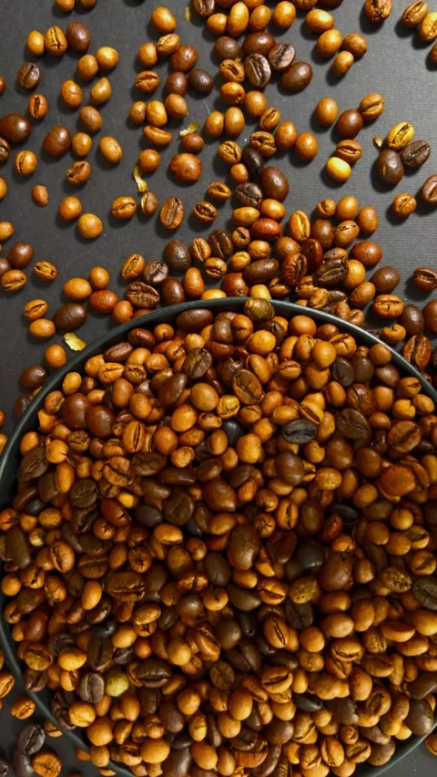 Roasted coffee beans in a bowl, vertical view Stock Footage 345155445