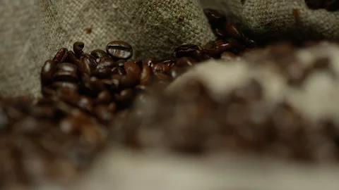 Roasted coffee beans capture on the burlap surface Video stock 142071349