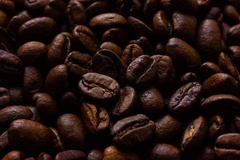 Roasted coffee beans close up background. Stock Photos