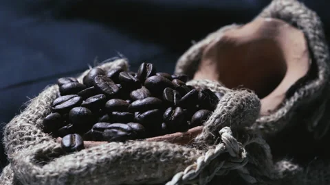 Roasted coffee beans in a cloth bag. Smoke from coffee roasting. Stock Footage 157315401
