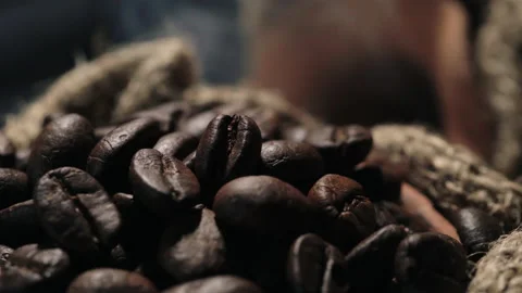 Roasted coffee beans in a cloth bag. Smoke from coffee roasting. Stock Footage 157758533
