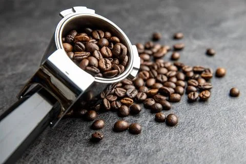 Roasted coffee beans in coffee filter holder Roasted coffee beans in coffe... Stock Photos