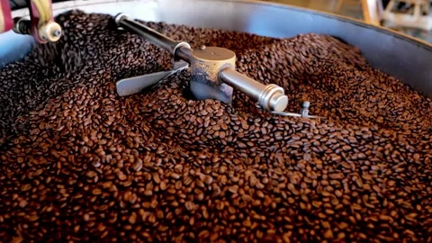 Roasted coffee beans in coffee roaster process Mixing and roasting process .. Stock Footage 272457183