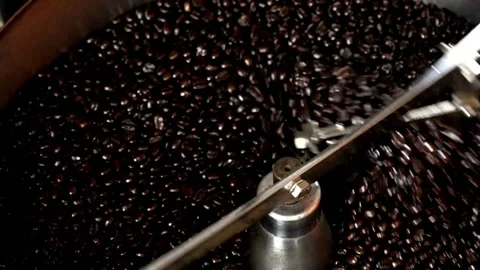 Roasted coffee beans in coffee roaster process Mixing and roasting process .. Stock Footage 272457504
