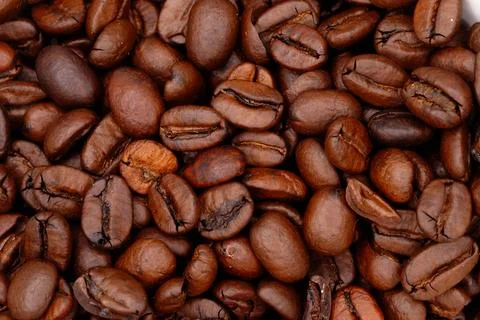 Roasted coffee beans creating aromatic beverage background Stock Photos