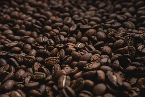 Roasted coffee beans creating a rich brown texture, representing the energi.. Stock Photos