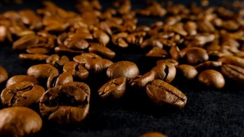 Roasted coffee beans creating textured background close up Stock Photos