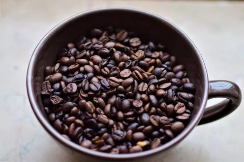 Roasted coffee beans in a cup as a close up Stock Photos