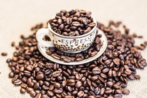 Roasted coffee beans with cup Stock Photos