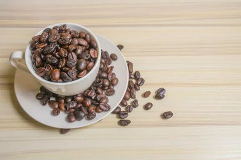Roasted coffee beans in cup 스톡 사진