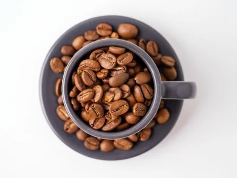 Roasted coffee beans in the cup. Stock Photos