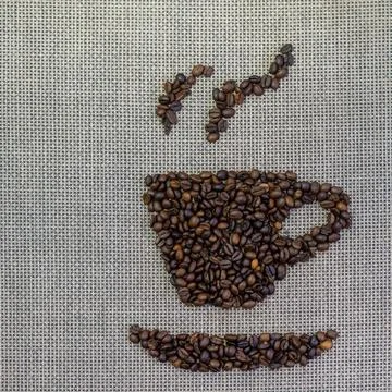 Roasted coffee beans in cup shape on burlap 写真素材