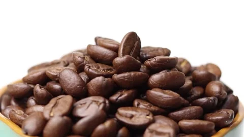 Roasted coffee beans on a cup with white background Stock Footage 169709764
