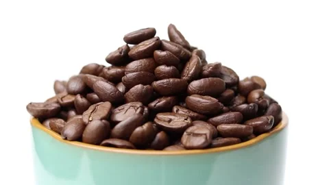 Roasted coffee beans on a cup with white background Stock Footage 169709823