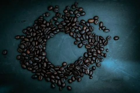 Roasted coffee beans on a dark background. Stock Photos
