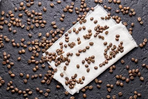 Roasted coffee beans, on dark background, closeup image, space for text Stock Photos