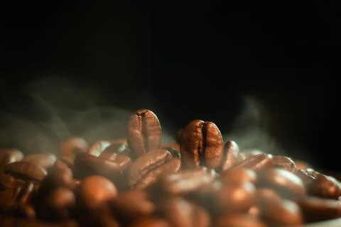 Roasted Coffee Beans on Dark Background Stock Photos