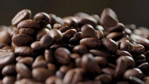 Roasted coffee beans dropping onto a pile Stock Footage 316071283