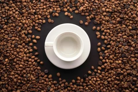Roasted coffee beans with empty cup of coffe Stock Photos