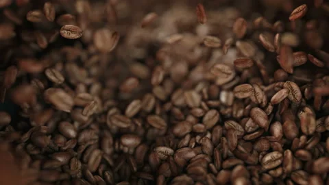 Roasted coffee beans exploding in slow motion 4K Stockbeeldmateriaal 164303613