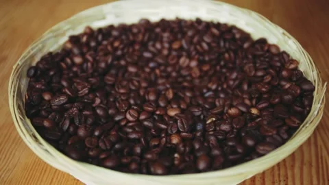 Roasted coffee beans fall into a bawl 库存影片 150402556
