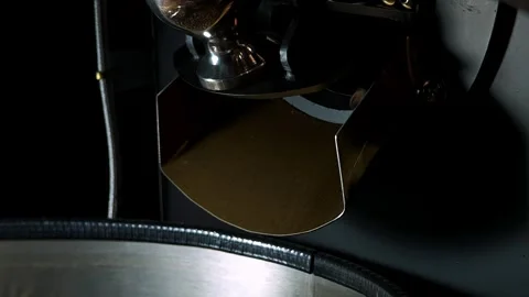 Roasted coffee beans fall out of roasting machine. Stock Footage 310846172