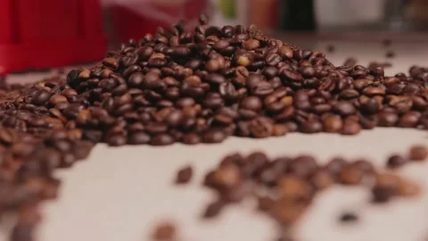 Roasted coffee beans fall on the table Stock Footage 142228492