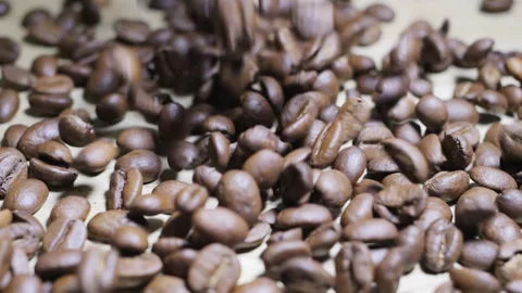 Roasted coffee beans falling and forming a pile Stock Footage 292302979