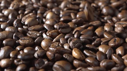 Roasted coffee beans falling down. Slow motion. Close-up shot Video stock 82097911