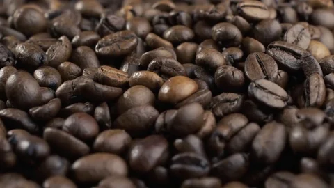 Roasted coffee beans falling down. Slow motion. Close-up shot Stock Footage 82100289