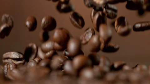 Roasted coffee beans falling down in super slow motion. Shooted with high speed Stock Footage 94786232