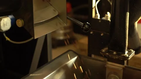 Roasted coffee beans falling out from cooling plate of roasting machine Stock Footage 234632584