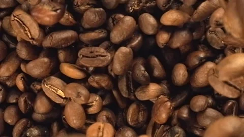 Roasted coffee beans falling in super slow motion macro top view Stock Footage 343507598