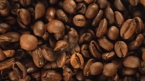 Roasted coffee beans falling in super slow motion macro top view Stock Footage 344849892