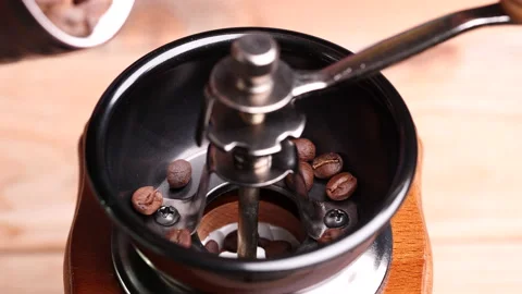 Roasted coffee beans falling into vintage manual coffee grinder. Stock Footage 153049958