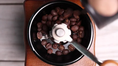 Roasted coffee beans falling into vintage manual coffee grinder. Stock Footage 153050326