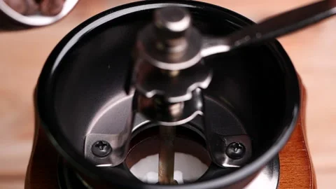 Roasted coffee beans falling into vintage manual coffee grinder. Video stock 153050605