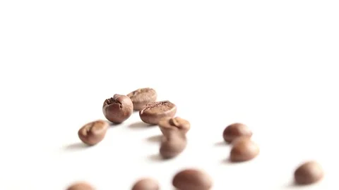 Roasted coffee beans falling on a white background Stock Footage 267036593