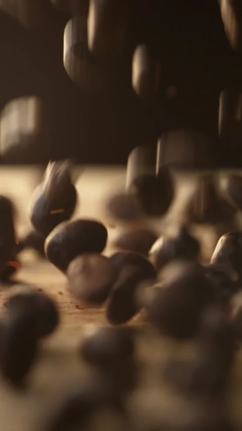 Roasted coffee beans falling on wooden surface 스톡 동영상 332923385