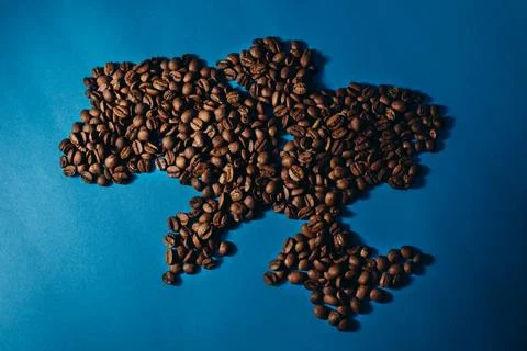 Roasted coffee beans forming shape map of Ukraine. Stock Photos